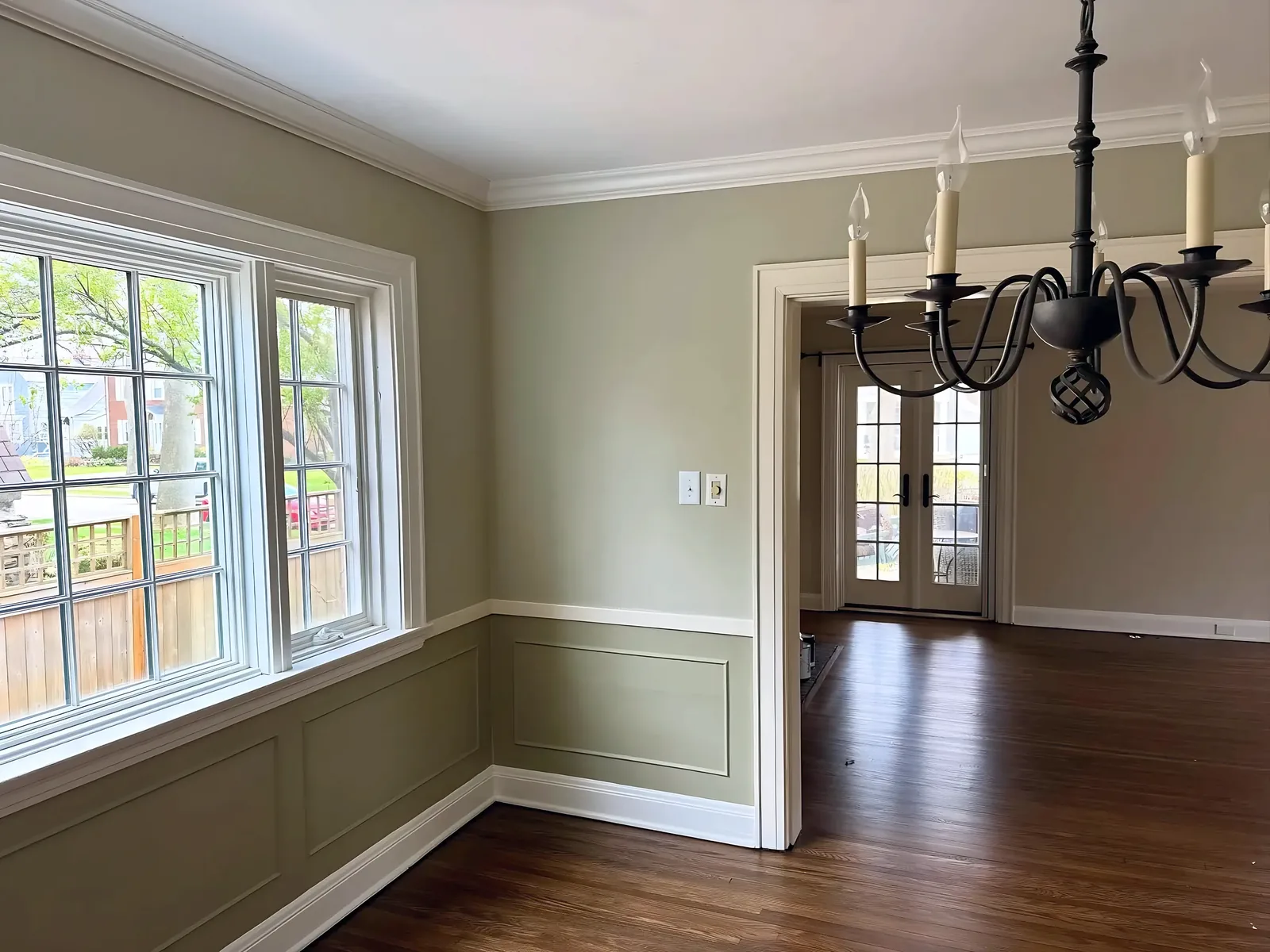 Sage dining room with wainscot